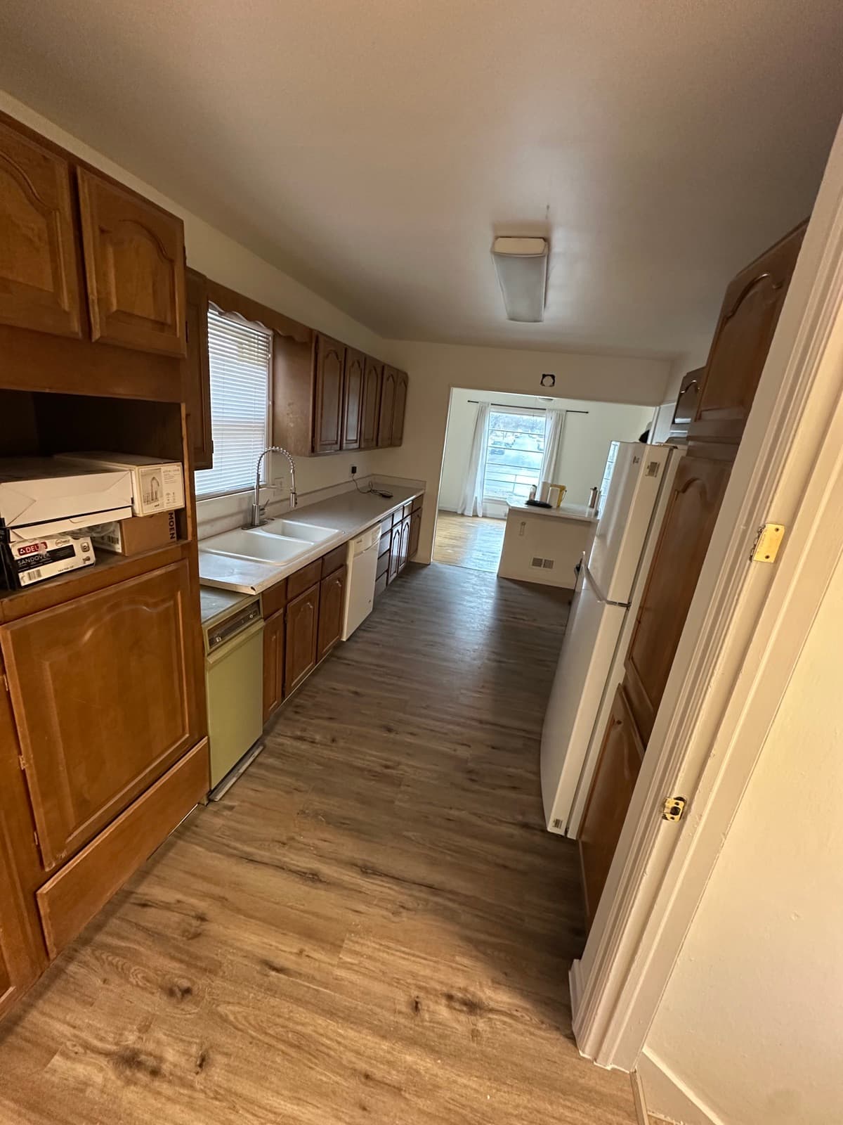 Waterproof LVP flooring installed in a Spokane kitchen with oak cabinets