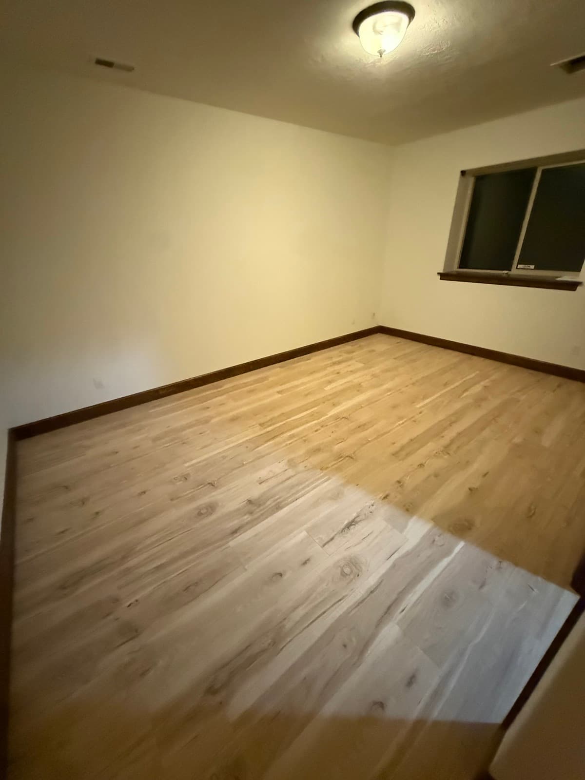Light luxury vinyl plank flooring installed in a Spokane-area bedroom