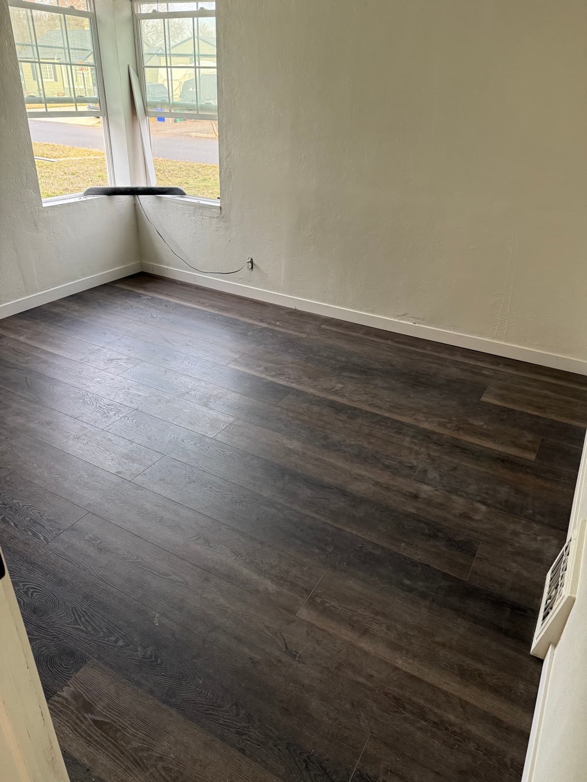 Dark luxury vinyl plank flooring in a bright room