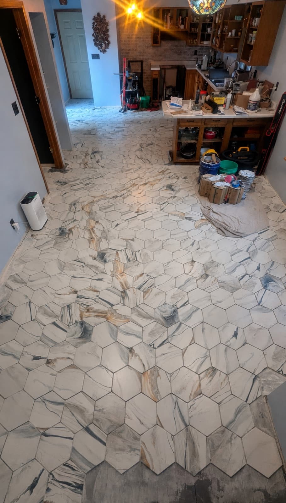 Marble-look hexagon tile floor installed in a Spokane kitchen by Happy Feet Flooring